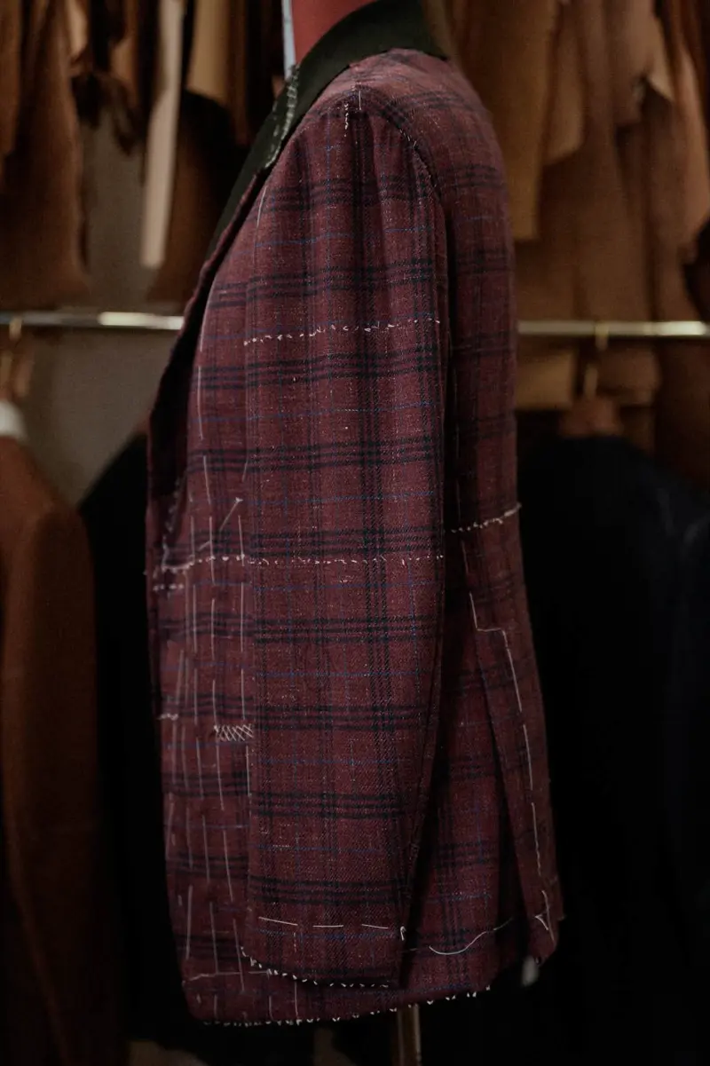 The unfinished jacket seen from the side, showing the shoulder, sleeve and back