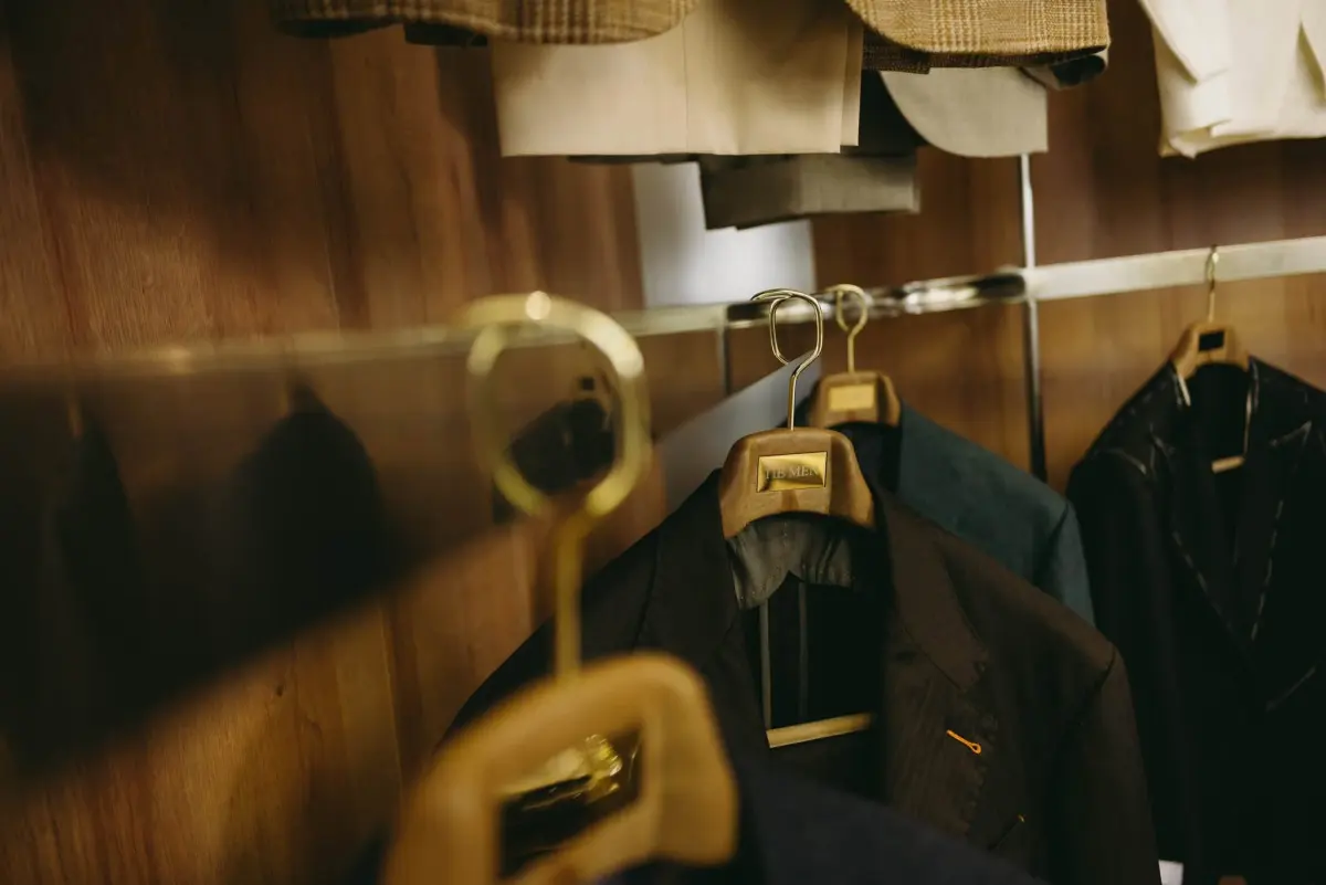 Jackets on hangers in warm light at the trunk show